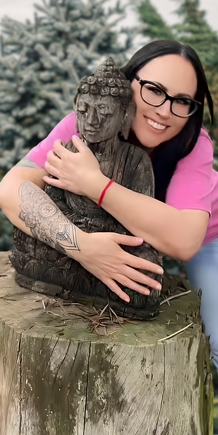 Tanya embracing a Buddha statue, a softer glimpse into who she is